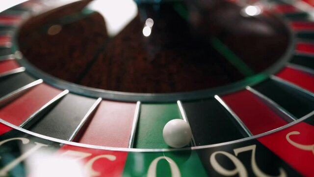 Casino roulette in motion. The spinning wheel ball. The ball hit to zero