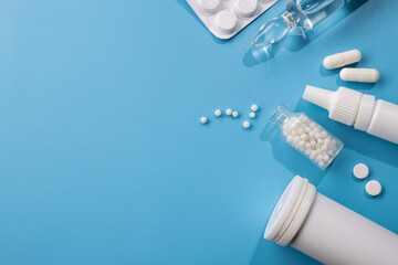 White pills and tablets on a blue table