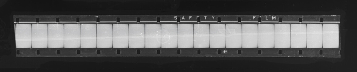 real scan of long black and white filmstrip with empty frames, flatbed scanner film image.