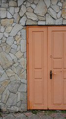 Orange color door and stone wall