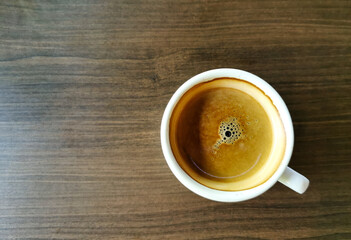 top view of coffee on brown wooden background