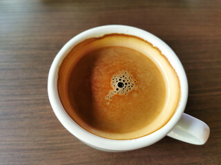 top view of coffee on brown wooden background