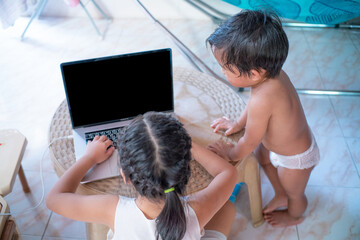 Cute and happy little girl children using laptop computer studying online internet