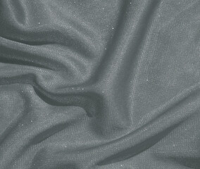 Shiny silver crumpled fabric. Wavy cloth background