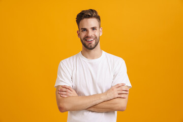 Joyful handsome guy smiling and looking at camera