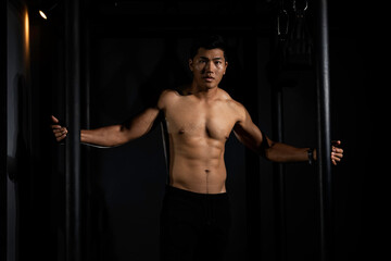 Fototapeta na wymiar Fitness asian man exercise training warm up body and posing in gym,Healthy lifestyle.