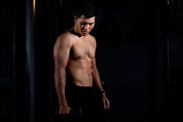 Fototapeta na wymiar Fitness asian man exercise training warm up body and posing in gym,Healthy lifestyle.