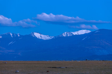 Mountain landscape at sunset. Outstanding view of the mountain ridges and clouds in Altai of Mongolia