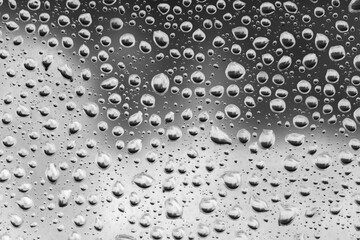 Raindrops on the window, black and white abstraction