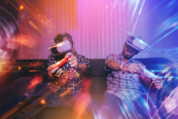 Happy friends enjoy playing video games virtual reality glasses in their home. Selected focus	