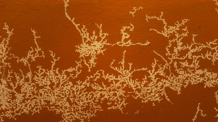 Brown paint Background cracked and peeling on the wall due to the influence of weather conditions...