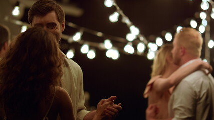 Friends dancing at new year party. Romantic couples talking with each other