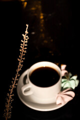 Retro a cup of coffee and a few meringues on black background. Minimalistic design for any purposes