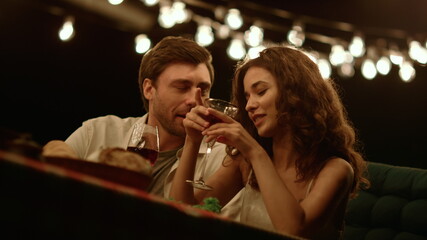 Man flirting with woman at romantic date. Cheerful couple talking together