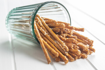 Salty sticks. Crunchy pretzels in glass.