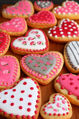 Heart shaped with lovely pattern cookies laid out on wooden tray