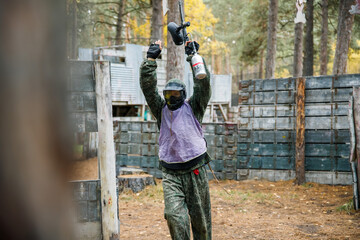 a man in the woods playing paintball