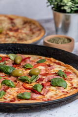 delicious homemade pizza with sauce, cheese ready to eat on white marble