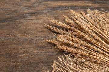 Ears of ripe wheat on a wooden board.