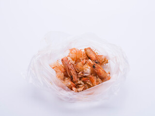 Shrimp food scraps in plastic bags on white background