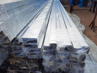 Anodized aluminium metal frames wrapped in polythene in a factory