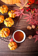 Pumpkin buns on the baking rack. Autumn concept.