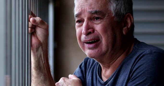 Older man crying with grief and pain. Senior person suffering alone