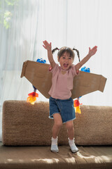 Happy Asian little child girl playing in an astronaut costume