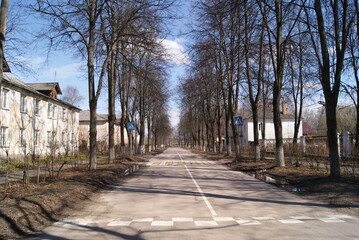 Noginsk, Moscow region, Russia - April 2020. Quiet provincial street in early spring. Trees without leaves along the road. Pedestrian crossing.