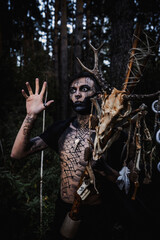 Sorcerer with marks on his body in the forest