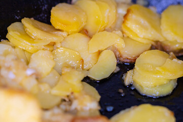 fried golden potatoes in a pan close-up