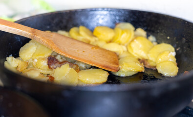 fried golden potatoes in a pan close-up