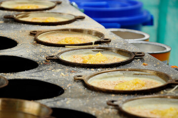Apam balik or Malaysian Peanut Pancake turnover.  Flour pancake stuffed with sugar and corn topping. Cooked using the hot pan. Famous street food in Malaysia. 
