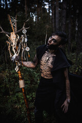 Sorcerer with marks on his body in the forest