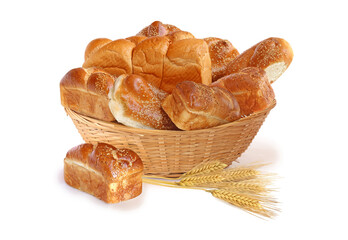 Bakery goods in a wicker basket with wheat of spikelets isolated on white