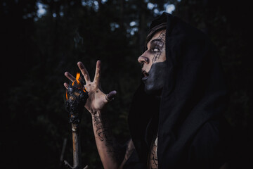 Sorcerer with marks on his body in the forest
