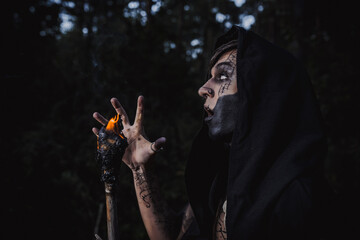Sorcerer with marks on his body in the forest