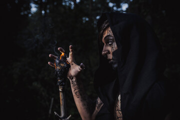 Fototapeta premium Sorcerer with marks on his body in the forest