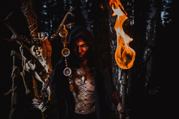 Sorcerer with marks on his body in the forest