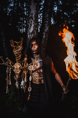 Sorcerer with marks on his body in the forest