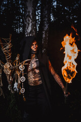 Sorcerer with marks on his body in the forest