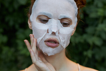 Nice woman Anti-wrinkle mask touch a finger near the face dermatology 