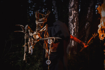 Sorcerer with marks on his body in the forest