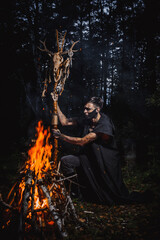 Sorcerer with marks on his body in the forest