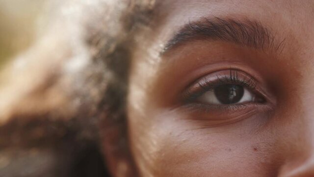 Close up macro Eyes of a black woman, african american woman portrait, mix raced young female, student teenager generation z