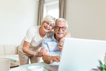 Elderly spouses at home. Wife hugs husband. Having pleasant conversation chatting with grown up children and grand children using wireless tech concept