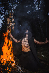 Sorcerer with marks on his body in the forest