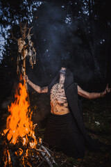 Sorcerer with marks on his body in the forest