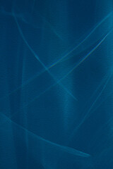 Glowing abstract lines on a dark blue background. The effect of penetrating light into the depths of the sea or ocean. Modern design concept for product presentation, mockup, template and wallpaper.