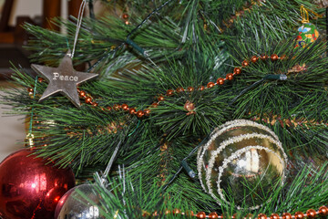 Christmas tree ornament gold ball on right for holiday winter themes.